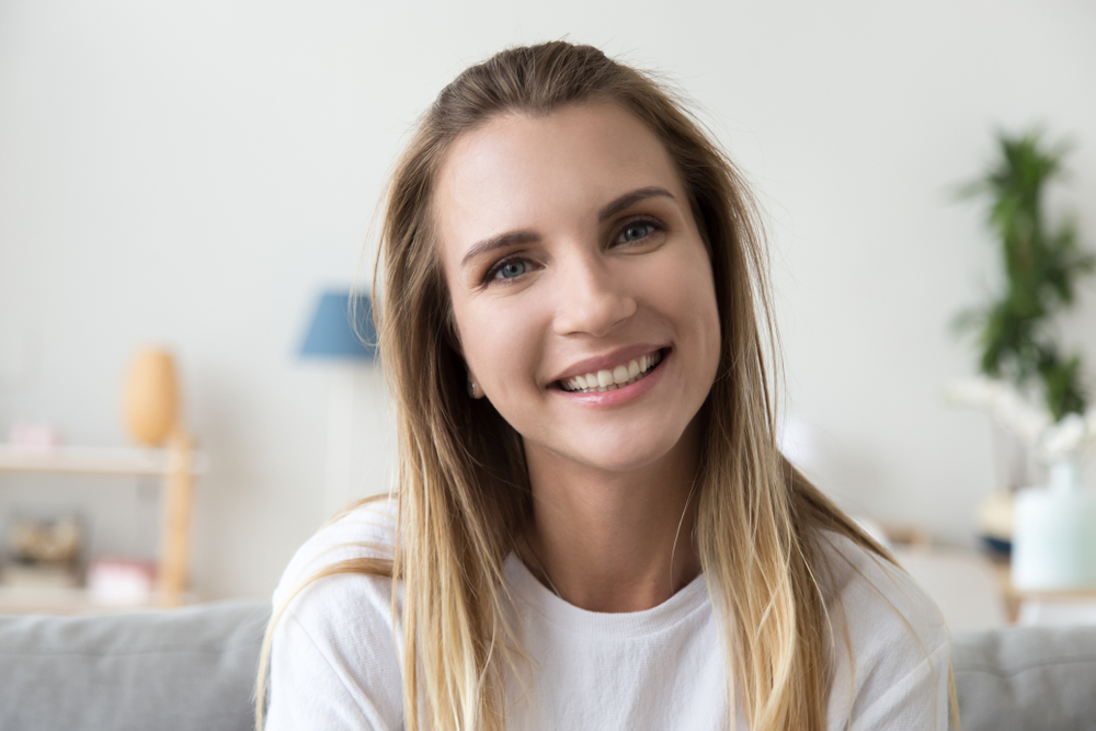 A woman with a bright smile representing confidence and clarity achieved through advanced LASIK eye procedures - LASIK eye surgery Philadelphia