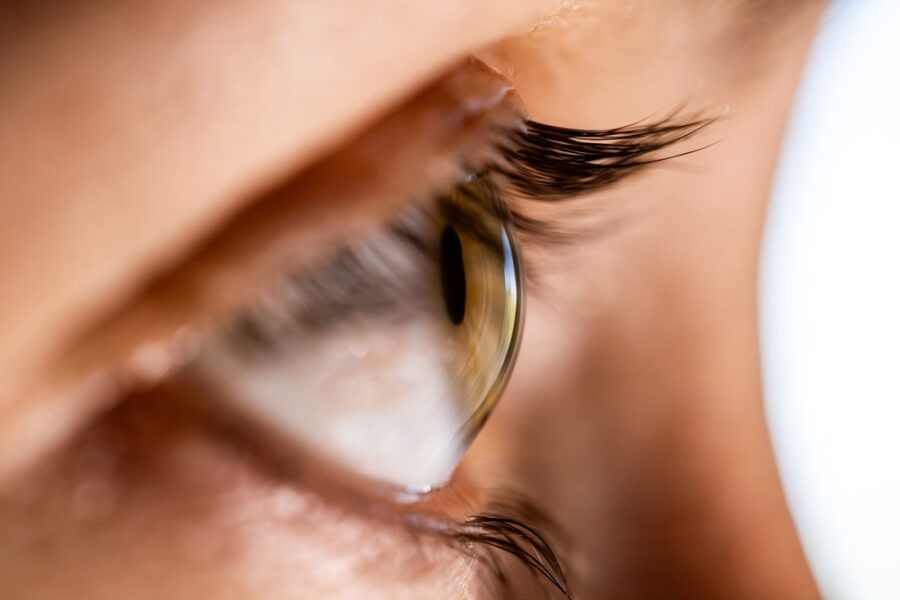 Extreme close-up of a human eye with visible eyelashes and natural skin texture, symbolizing the delicate healing process and recovery timeline associated with upper eyelid surgery – Upper Eyelid Surgery Healing Time
